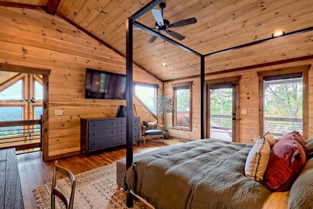 bedroom featuring wood walls, access to outside, wooden ceiling, and lofted ceiling with beams