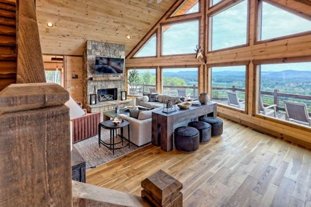 living area featuring wood walls, a fireplace, wood ceiling, wood-type flooring, and high vaulted ceiling