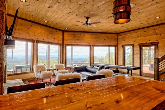 interior space featuring a ceiling fan, recessed lighting, wooden ceiling, wood walls, and a mountain view