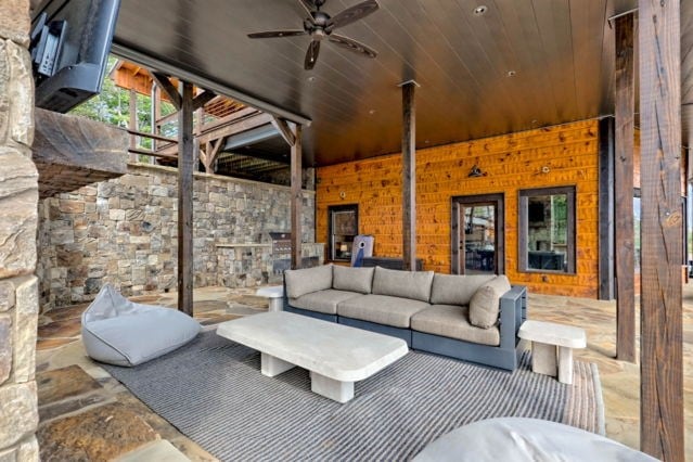 living room with a ceiling fan and wooden ceiling
