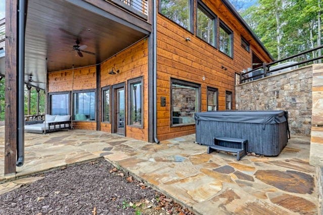 view of patio with a ceiling fan and a hot tub