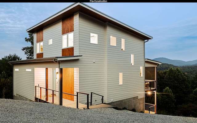 back of property with a mountain view