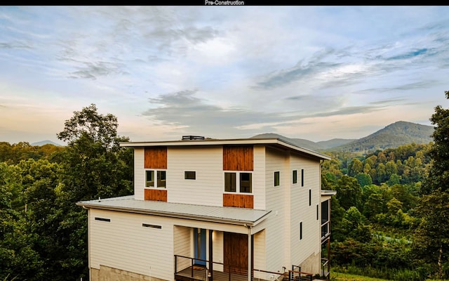 view of back house at dusk