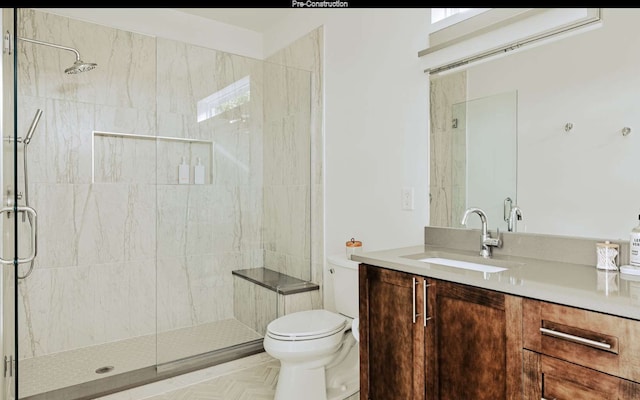 bathroom with parquet flooring, vanity, toilet, and a shower with shower door