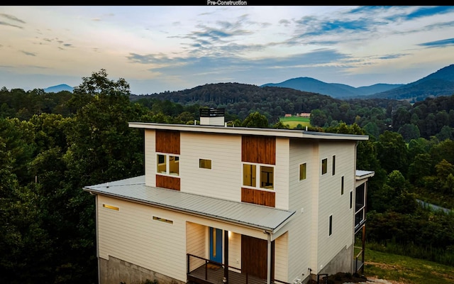 back house at dusk featuring a mountain view