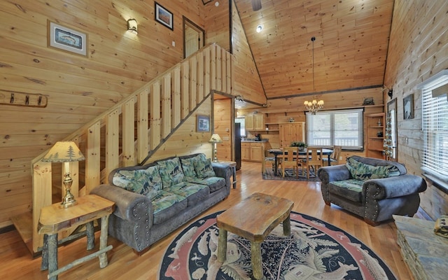 166 Dallas Ln, Blue Ridge, GA 30513 - living room featuring wood walls, high vaulted ceiling, light wood-type flooring, wooden ceiling, and a notable chandelier