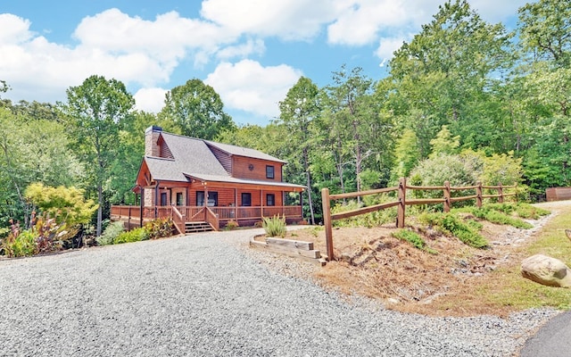 166 Dallas Ln, Blue Ridge, GA 30513 - view of front facade featuring a view of trees, a chimney, and a wooden deck