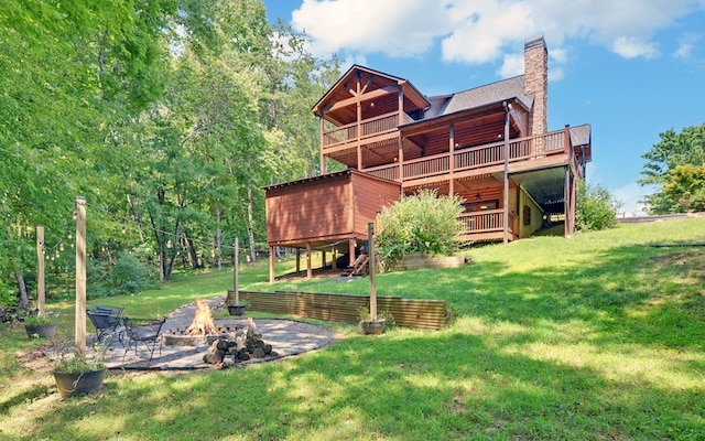 166 Dallas Ln, Blue Ridge, GA 30513 - rear view of house featuring a wooden deck, a chimney, a yard, and an outdoor fire pit