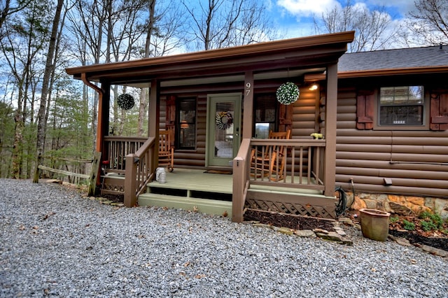 exterior space with a shingled roof and covered porch