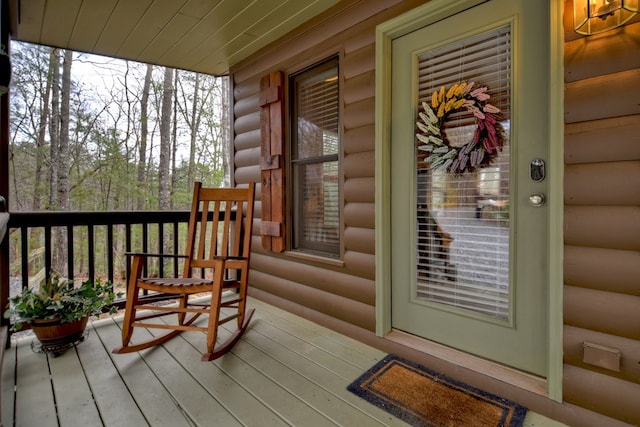 wooden terrace featuring covered porch