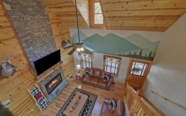 unfurnished living room featuring a fireplace, high vaulted ceiling, wooden ceiling, and wood finished floors