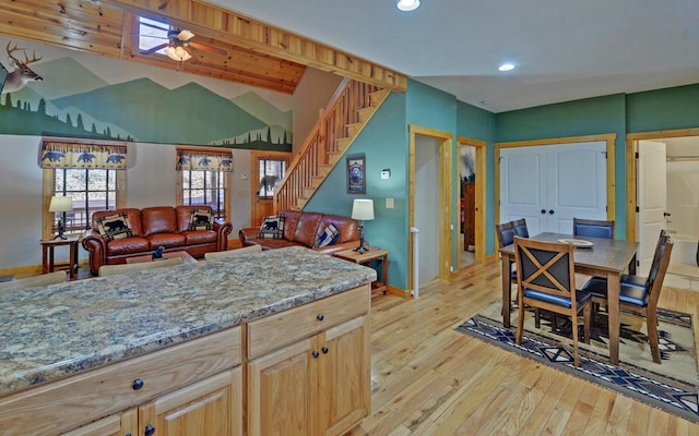 kitchen with a ceiling fan, light stone counters, recessed lighting, light wood finished floors, and baseboards