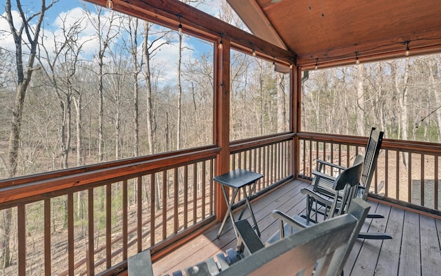 wooden deck with a view of trees