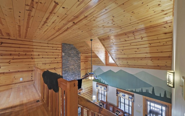 bonus room featuring hardwood / wood-style floors, wooden ceiling, wooden walls, and vaulted ceiling