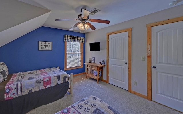 carpeted bedroom with visible vents, baseboards, a ceiling fan, and vaulted ceiling