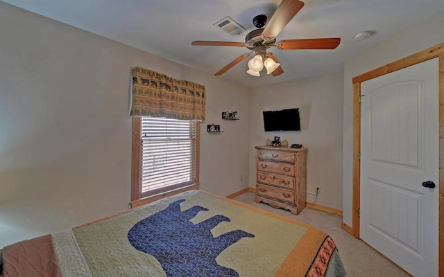 bedroom with visible vents, light carpet, baseboards, and ceiling fan