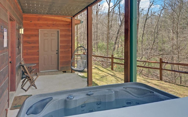 sunroom featuring a jacuzzi