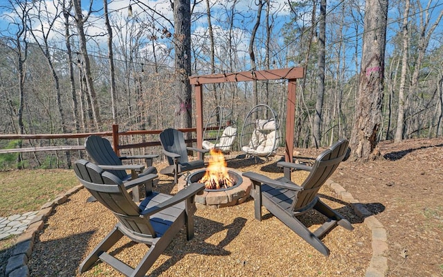 view of yard with a fire pit and a forest view