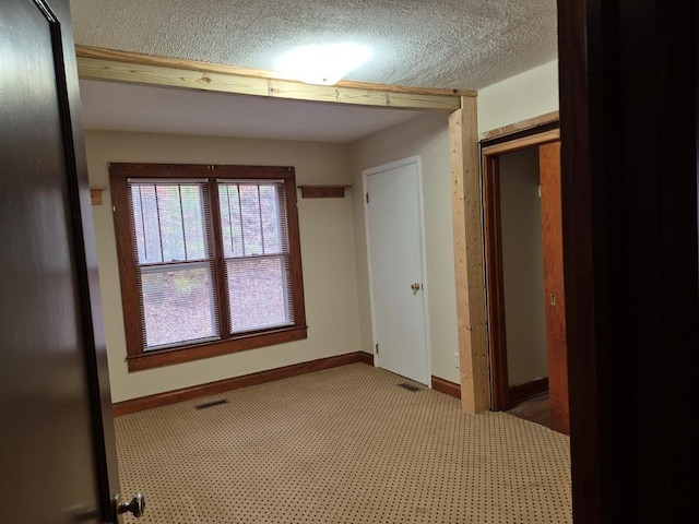 empty room featuring a textured ceiling