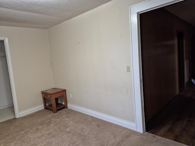 unfurnished bedroom with carpet and a textured ceiling