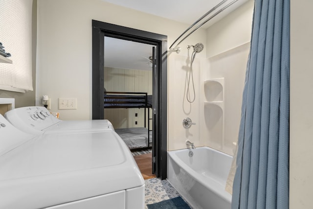 bathroom featuring washing machine and dryer and shower / bathtub combination with curtain