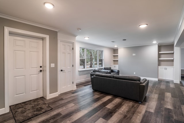 living area with built in features, dark wood-style flooring, crown molding, and baseboards