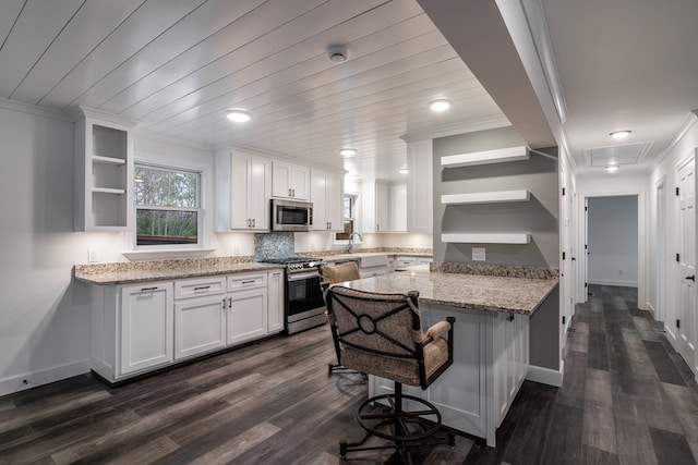 kitchen featuring white cabinets, appliances with stainless steel finishes, open shelves, and light stone counters