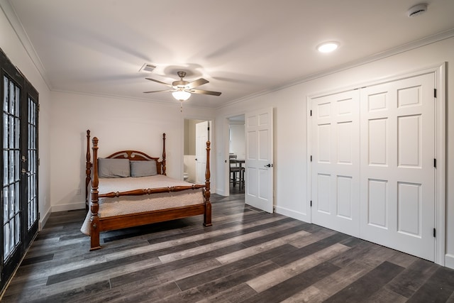 bedroom with baseboards, visible vents, dark wood finished floors, and ornamental molding