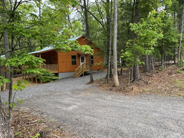 151 Martins Creek Ridge Rd, Murphy, NC 28906 - view of front of house with faux log siding, crawl space, metal roof, a porch, and driveway