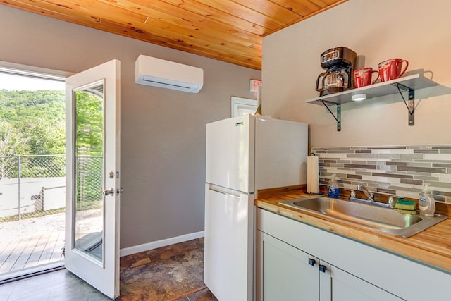 kitchen featuring a wall mounted air conditioner, white refrigerator, sink, butcher block countertops, and wood ceiling