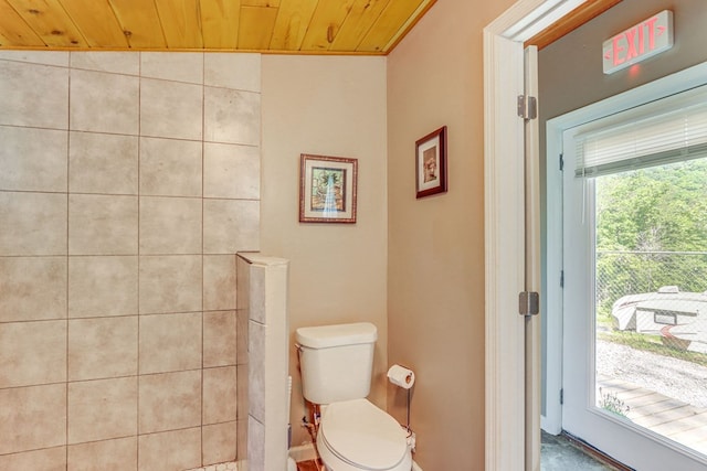 bathroom with toilet, lofted ceiling, and wood ceiling