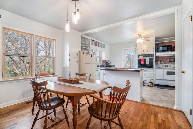 dining area featuring ceiling fan and light hardwood / wood-style flooring