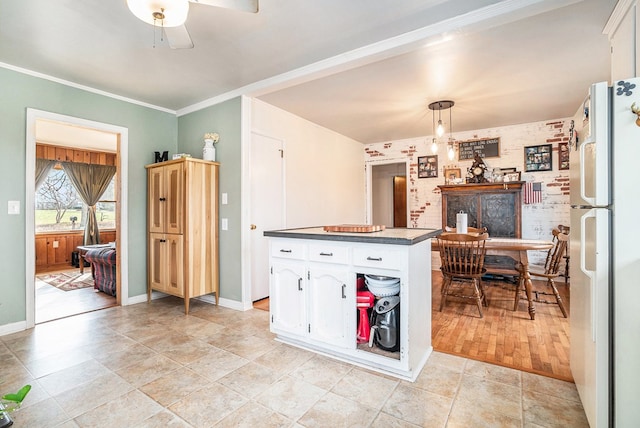 kitchen with pendant lighting, white cabinetry, white fridge, ceiling fan, and crown molding