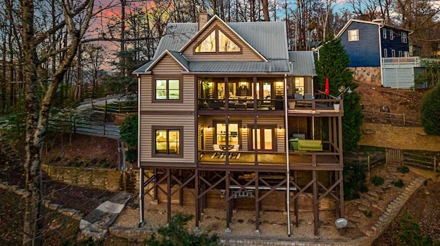 view of back house at dusk