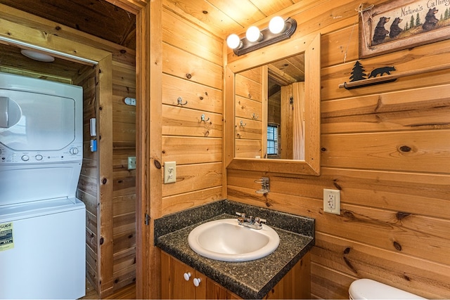 93 Lazy Bear Trl, Andrews, NC 28901 - half bath featuring stacked washer / drying machine, wooden walls, vanity, and toilet