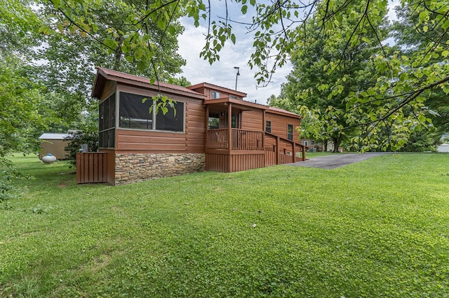 93 Lazy Bear Trl, Andrews, NC 28901 - back of property with a lawn and a sunroom