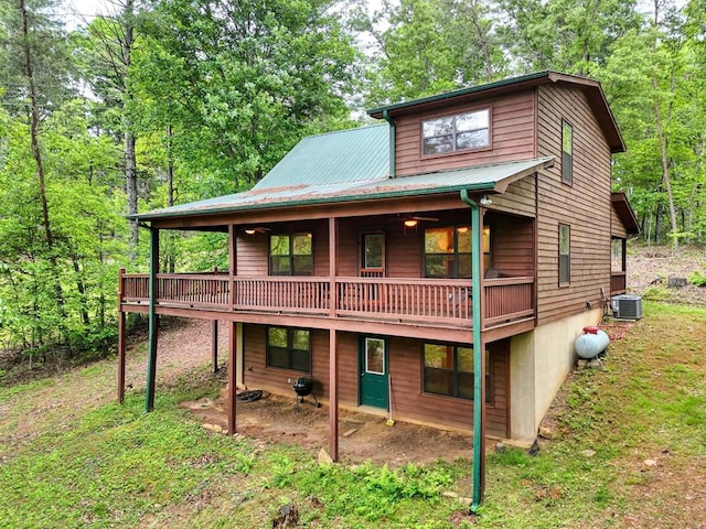 back of house featuring a balcony and central AC unit