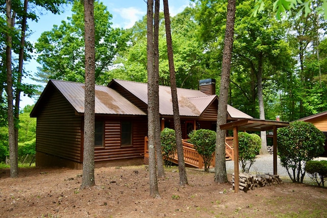115 Black Oak Ridge Rd, Blue Ridge, GA 30513 - view of front facade with log veneer siding, a chimney, and metal roof