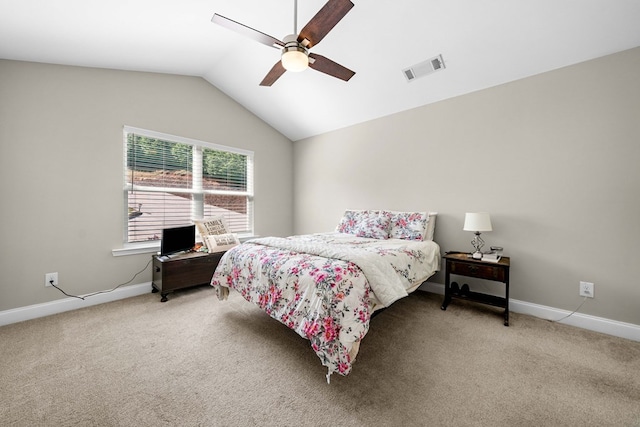bedroom with visible vents, baseboards, lofted ceiling, and light colored carpet