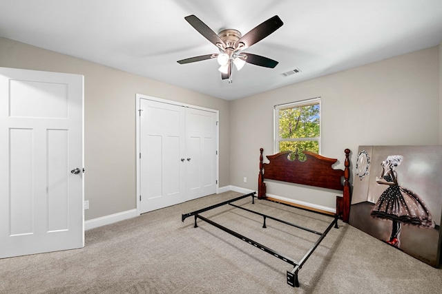 carpeted bedroom with a ceiling fan, baseboards, visible vents, and a closet