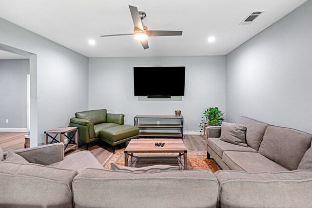 living room featuring baseboards, recessed lighting, wood finished floors, and visible vents