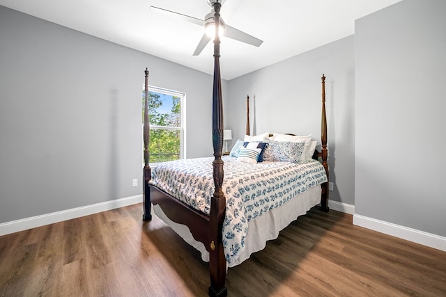 bedroom featuring a ceiling fan, baseboards, and wood finished floors