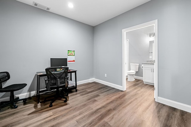office featuring baseboards, recessed lighting, wood finished floors, and visible vents