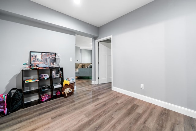 interior space with baseboards, recessed lighting, and wood finished floors