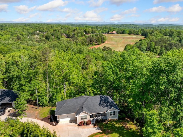 drone / aerial view featuring a forest view