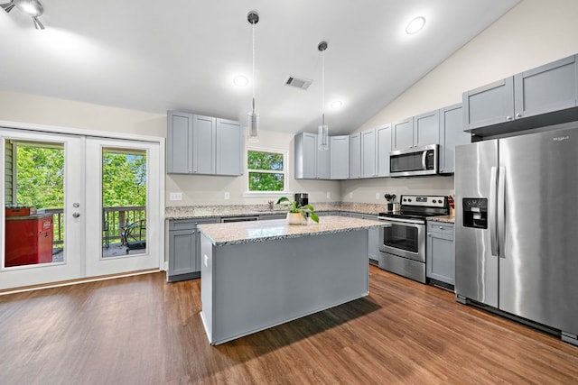 kitchen with visible vents, gray cabinets, appliances with stainless steel finishes, and lofted ceiling