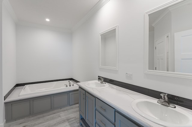 bathroom featuring wood-type flooring, vanity, a tub to relax in, and crown molding