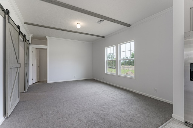 unfurnished bedroom with ornamental molding, a textured ceiling, light colored carpet, a barn door, and beamed ceiling