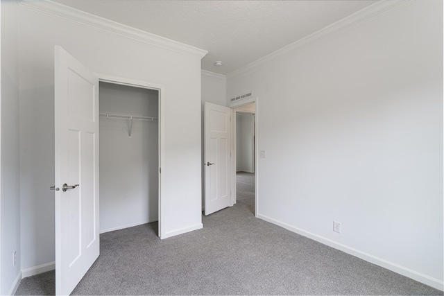 unfurnished bedroom with carpet floors, a closet, and crown molding