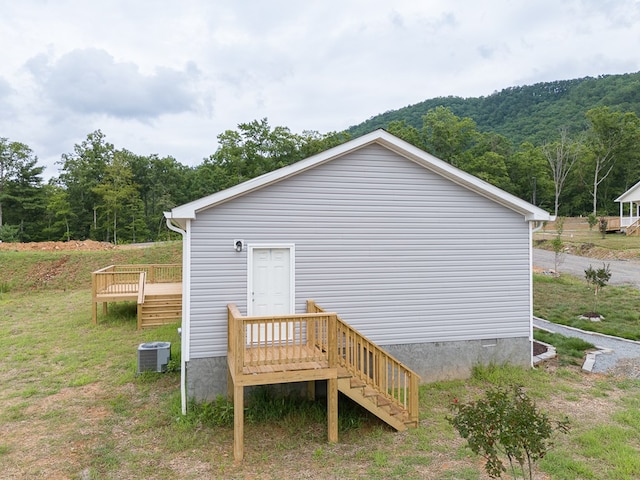 view of side of home featuring central AC and a deck